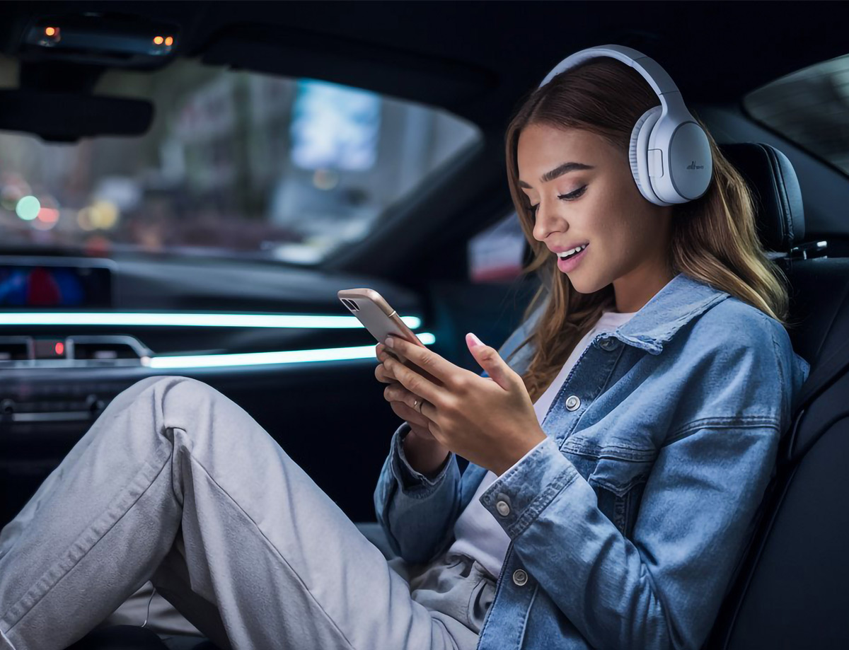 Jeune femme écoutant une publicité sur Spotify sur son mobile dans une voiture