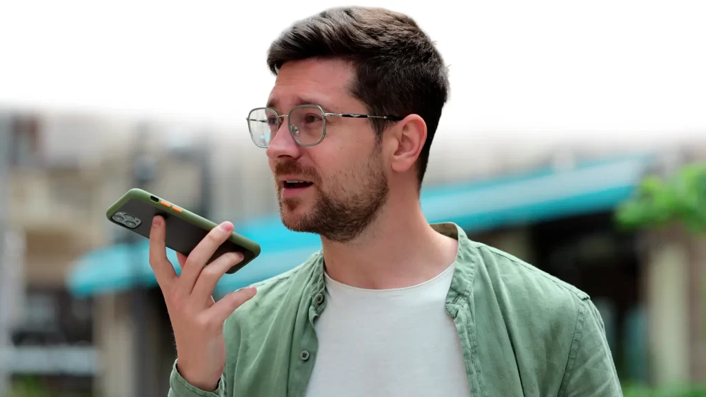 Man using a smartphone for voice search SEO for SMB